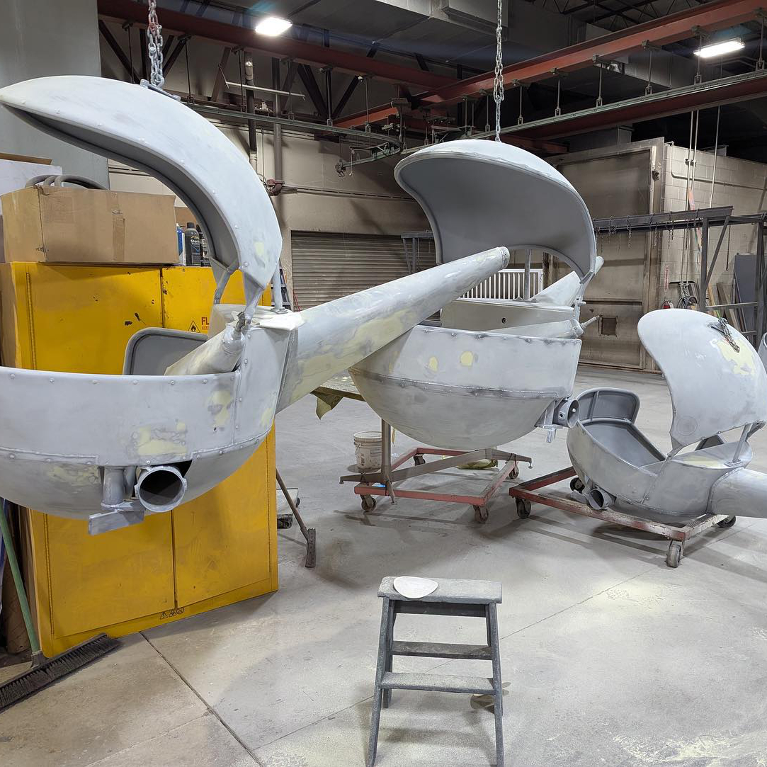 Ride carriers for the new Rivets and Rotors ride at Lagoon sitting in a warehouse. These helicopter-shaped ride vehicles are primted for their new paint job.