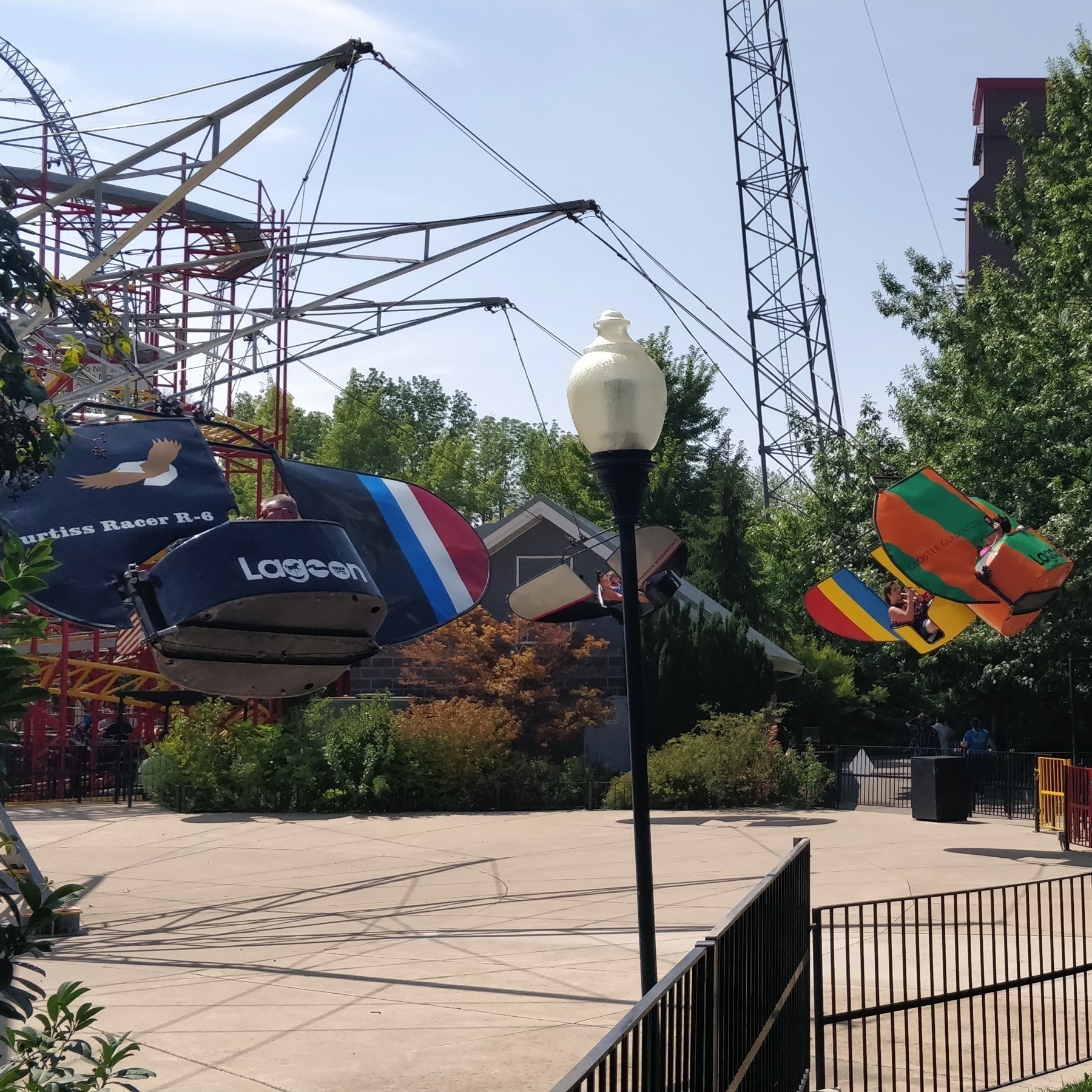 Flying Aces at Lagoon. Ride is in motion with people in the carriers.