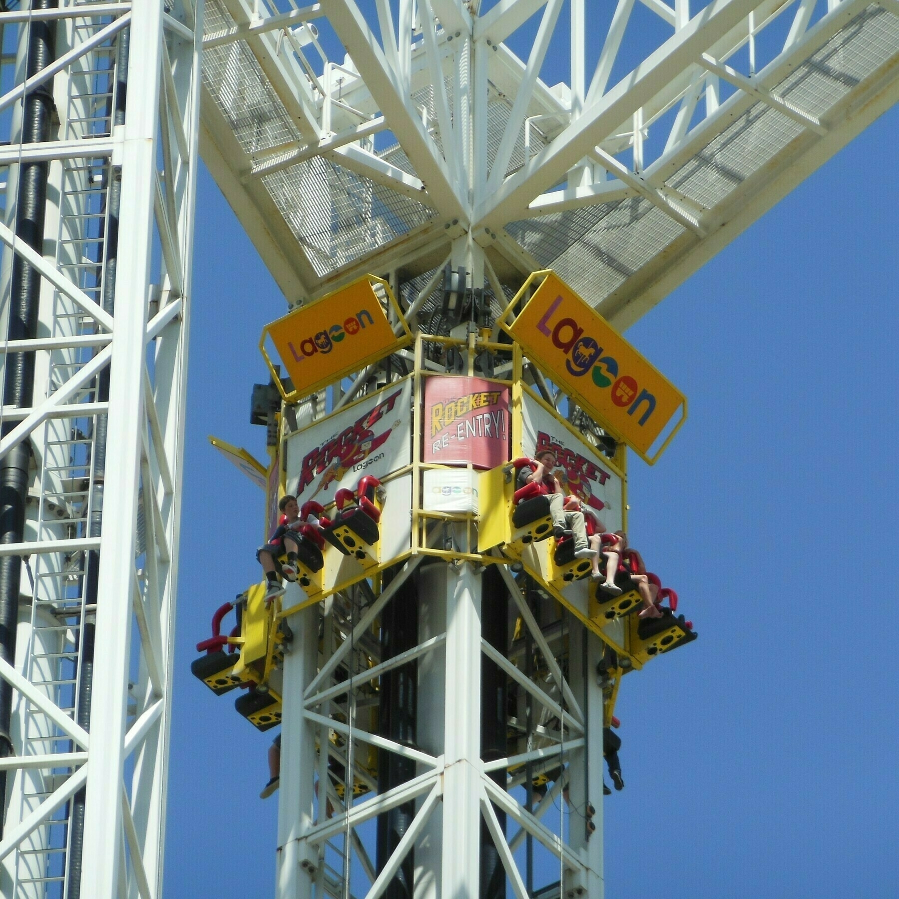 An image of Rocket at Lagoon Amusement Park. The image features the carrier of the Re-Entry tower at the top of the Rocket tower preparing for the vertical downward launch.