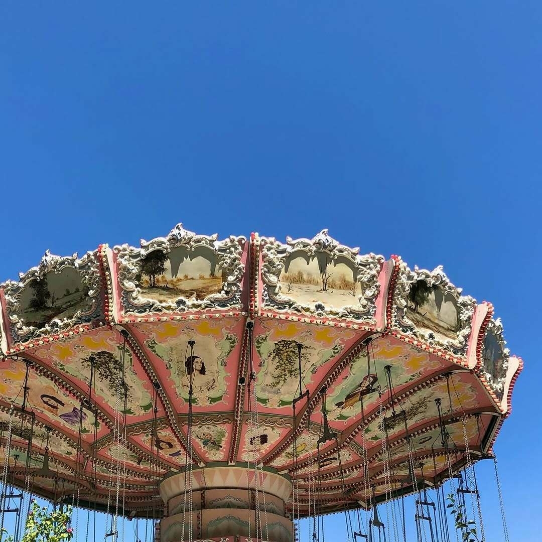 An image of the top part of the Turn of the Century ride at Lagoon. A clear blue sky can be seen in the background.